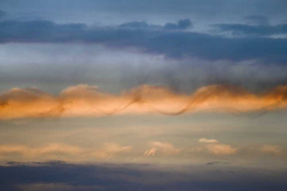 Utah, Arches NP Sunset sky with a spiral cloud
